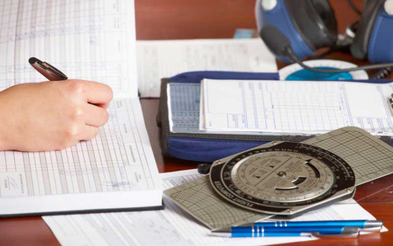Filling out a paper logbook