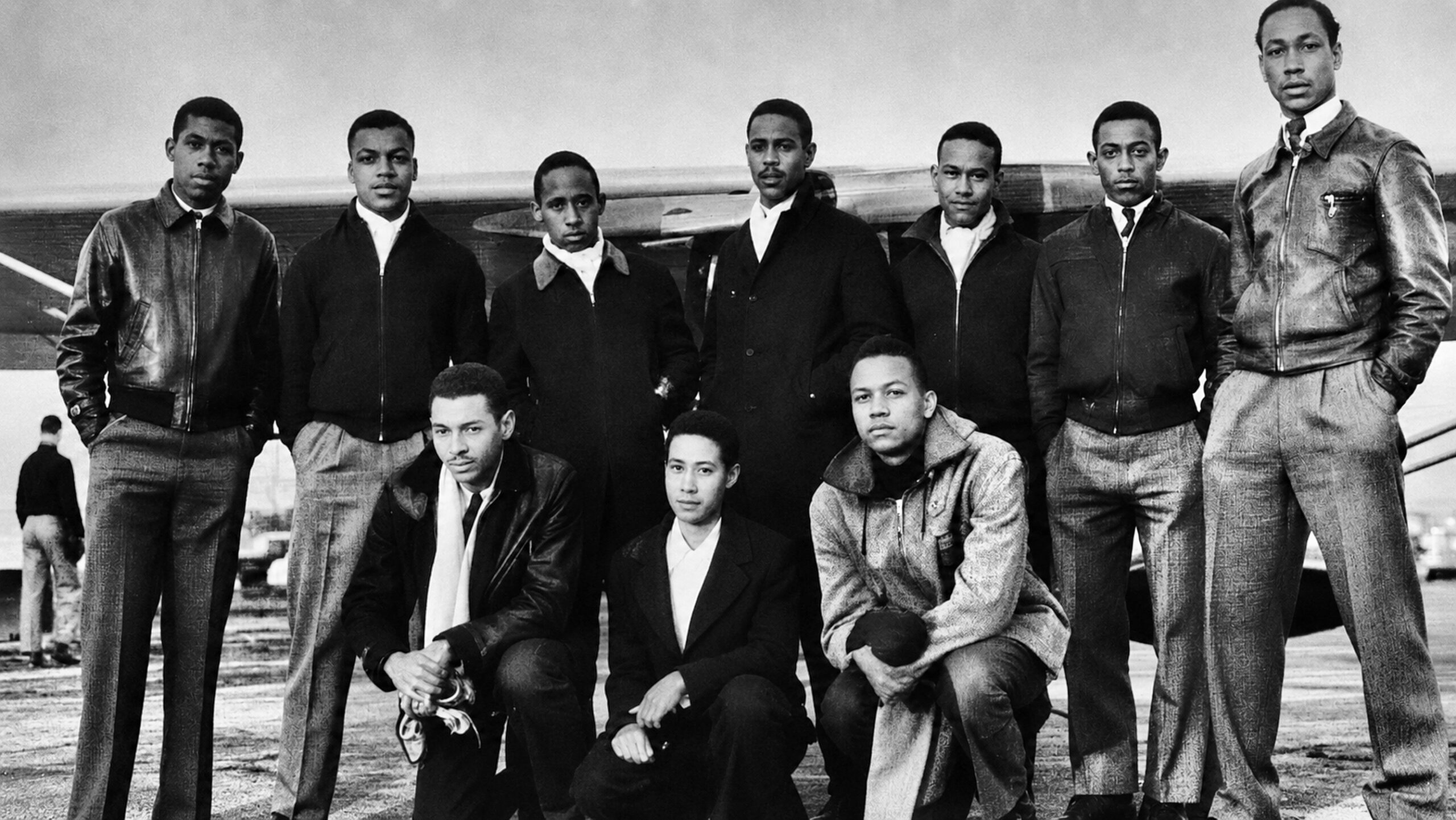 Hampton Institute Civilian Pilot Training Program trainees standing before a training aircraft in the early 1940s