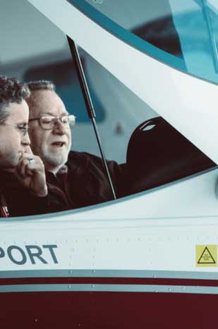 Flight instructor teaching student in cockpit